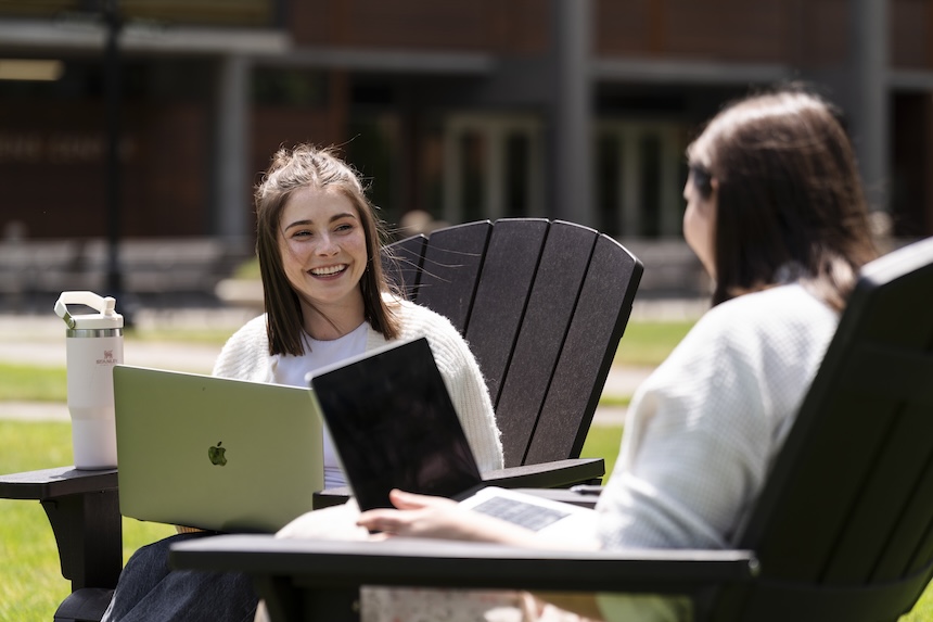 Student working on laptops on campus
