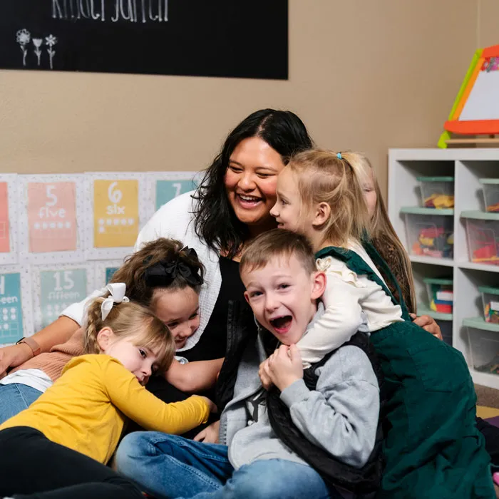 Teacher smiles in a big group hug