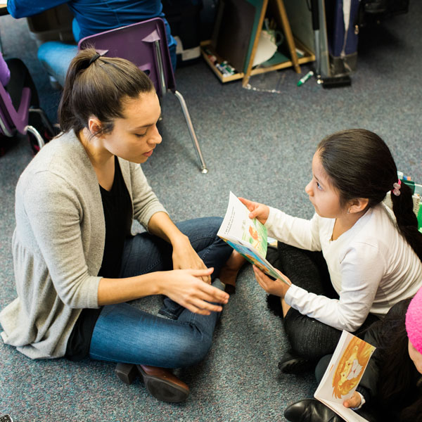 student teacher reads with young student