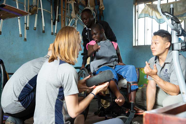 Students of the program discuss care for a patient