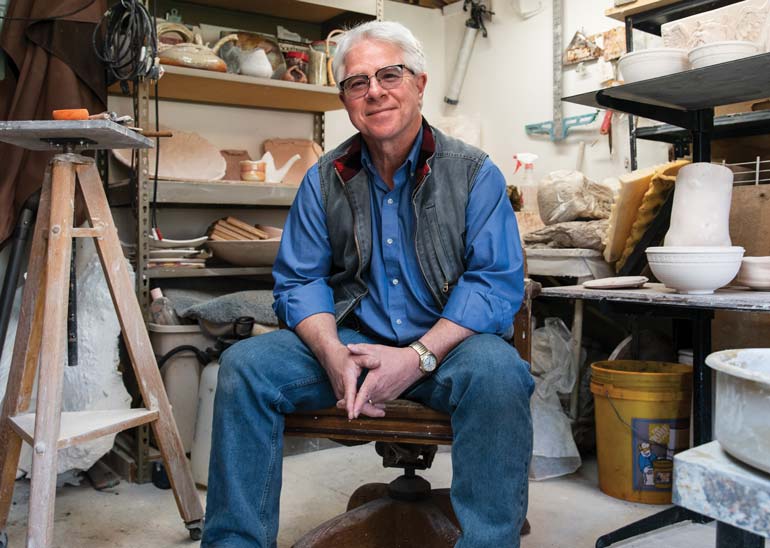 Mark Terry sitting in the pottery lab