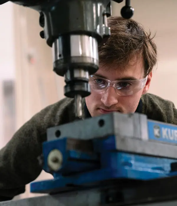 Mechanical engineering major Nathan Hayward uses a milling machine