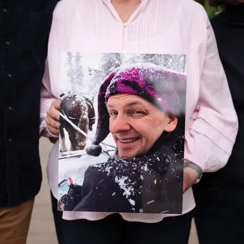 Christine holds a photo of her husband