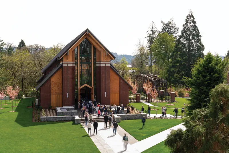 A bird's eye view photo of students walking into the chapel on a bright, overcast day