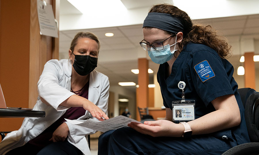 Nursing student talking with a professor