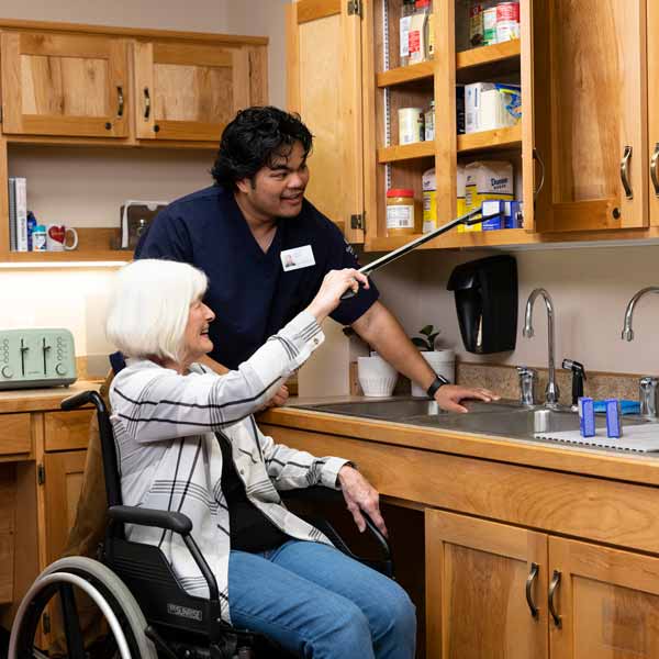 OT student helps elderly woman bake