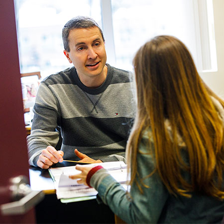 Student having a discussion with faculty mentor