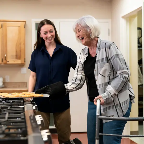A George fox employee works with an older family member to make cookies