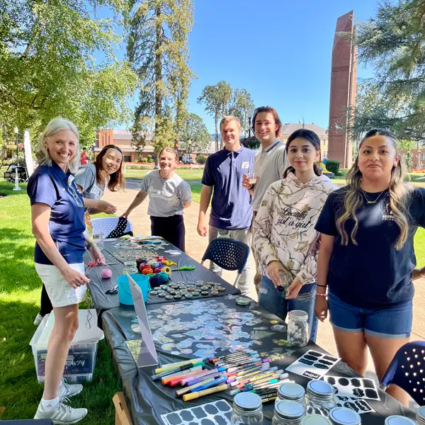 7 employees pose for a photo at a George Fox wellness social event