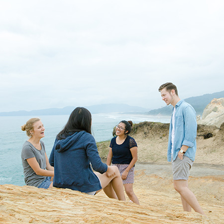 A group of students having conversation on the beach