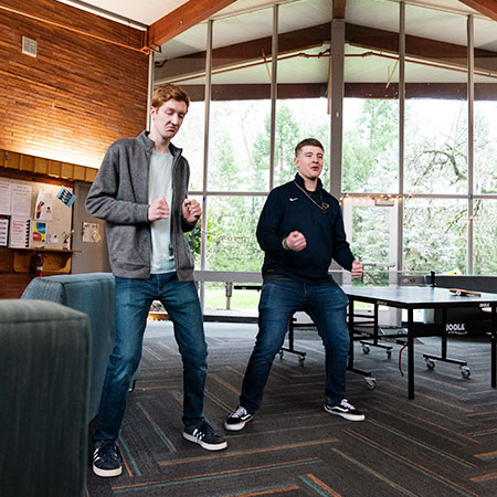 Two friends having fun in their dorm