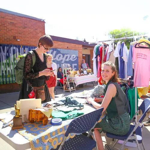 A student purchases something from the spring market outside