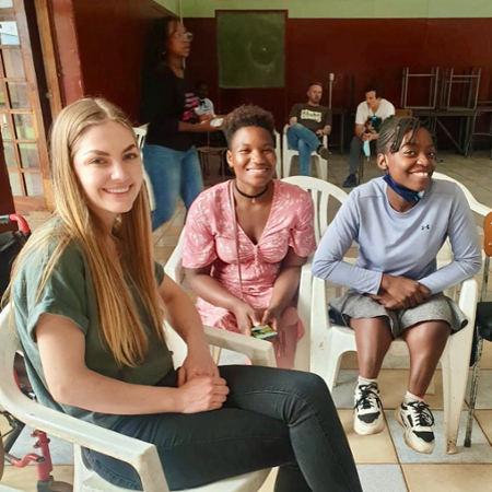 a PA student with two patients during a service trip