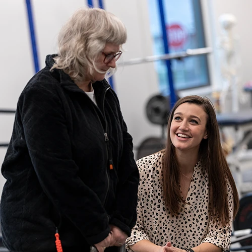 a student assists an elderly woman