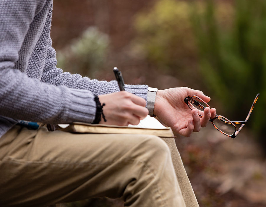 A student sitting with the Bible and writing notes