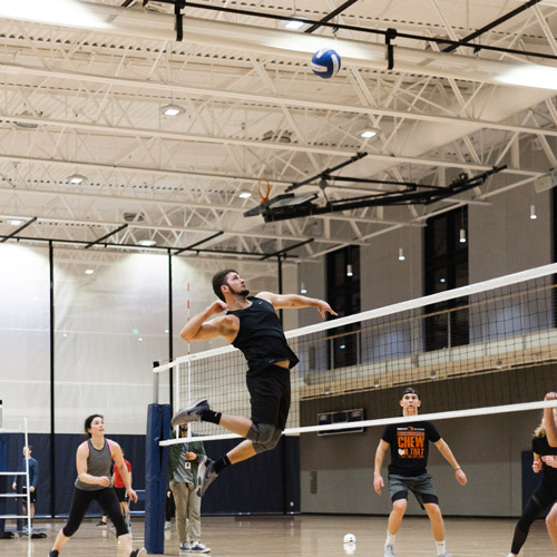 student spiked vollyball over the net