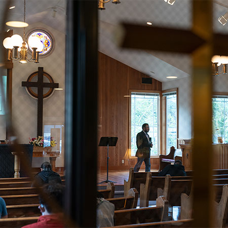 Interior of a church showing a pastor speaking to congregation