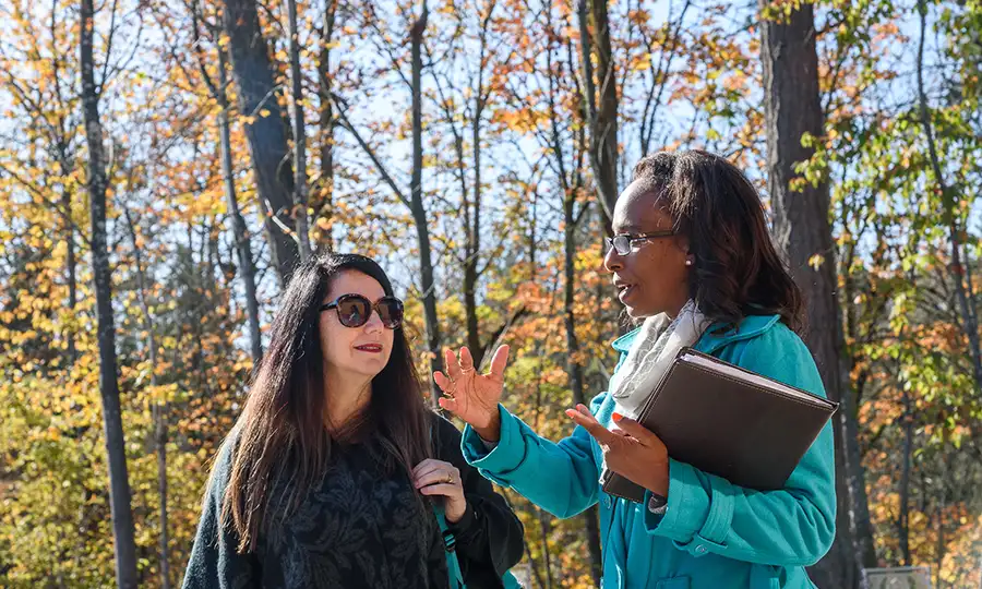 woman speaking to fellow student