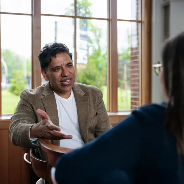 A pastor engages in a conversation with someone in their church