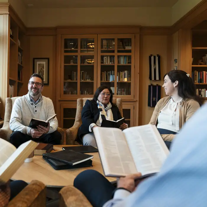 Seminary students sitting in a cozy circle reading their Bibles