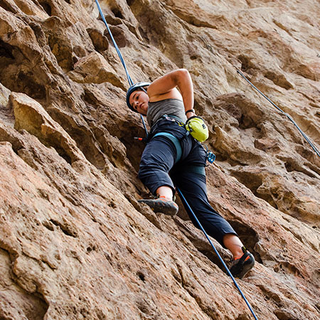 A student participating in a rock climbing event through Hadlock student center